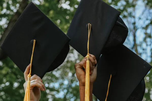 Students holding up their graduation caps