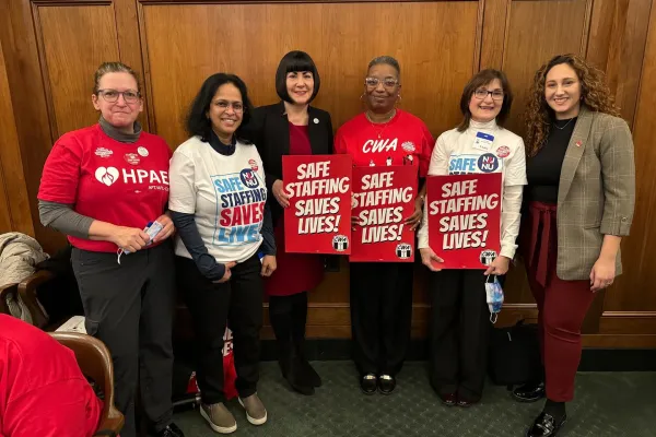 CWA Members and Staff hold signs saying "Safe Staffing Saves Lives"