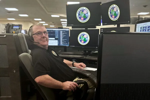 Member Bill Haines sitting at his dispatch desk