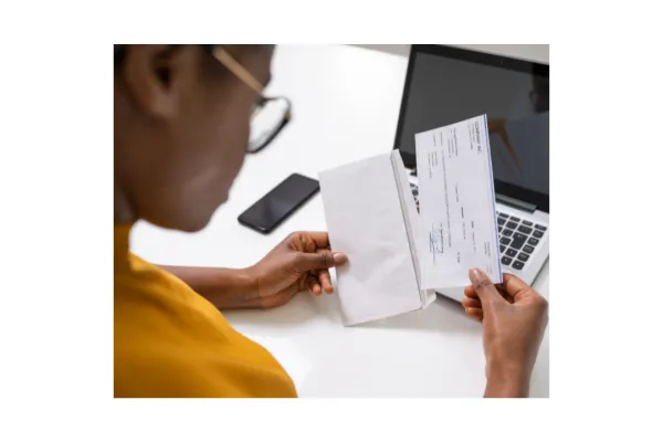 Woman looking closely at her paycheck