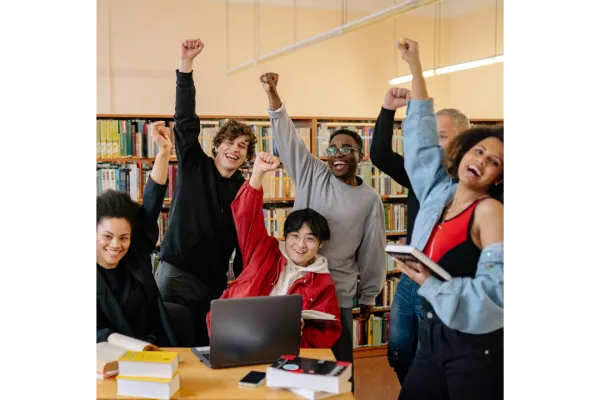 College students in a library with their fists up 