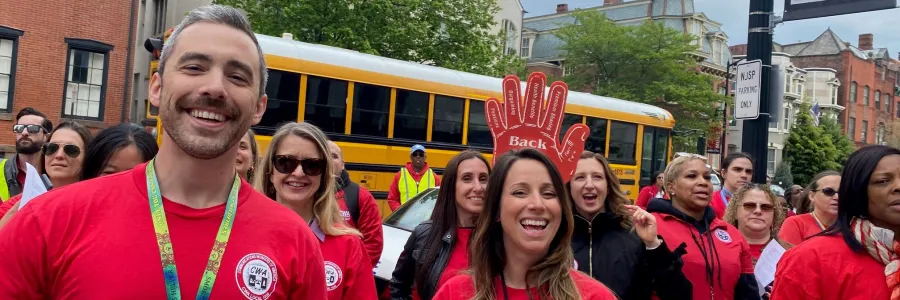 Members in red picketing at their worksite