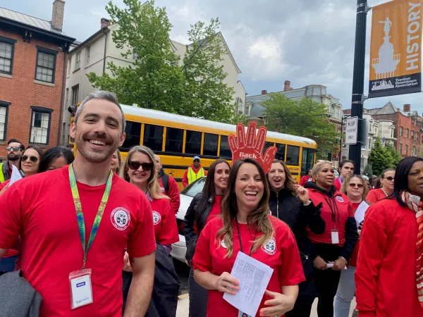 Staff and members smiling as they picket together