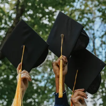 Students holding up their graduation caps